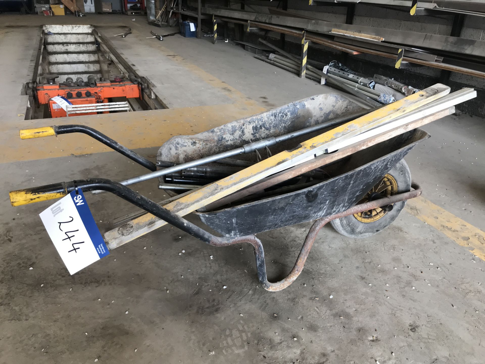 Steel Wheelbarrow, with contents including spirit levels and jack handles (lot located at Bedfords
