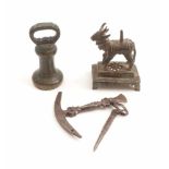 Flint knapping tool, small bronze statue and a weight18th C.Bronze, iron. L. 12 to 13 cm.Drei