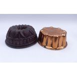 Two baking moulds19th centuryRound shape, one with inner tube, flanged edge. Copper, tinned