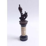 Equestrian figureAfricaRider with mask on a fantasy animal, high pedestal with ivory trimming