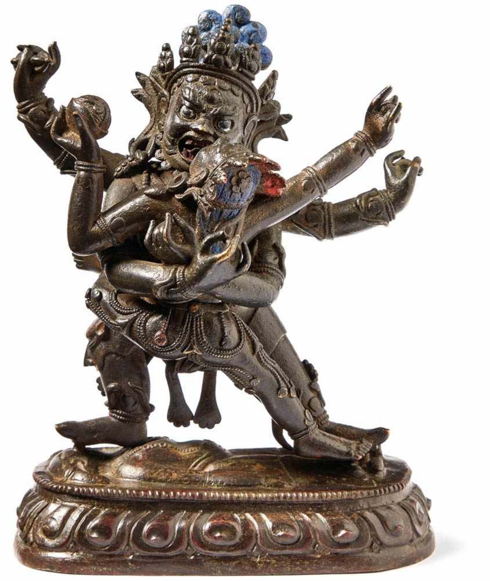 Dharmapala Begtse with Shakti in Yab-yumTibetA four-armed deity standing on a lungeing body on a