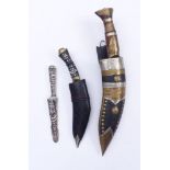 Three daggers19th centuryTwo Nepalese Khukuri with a characteristic notch in a wooden sheath and a