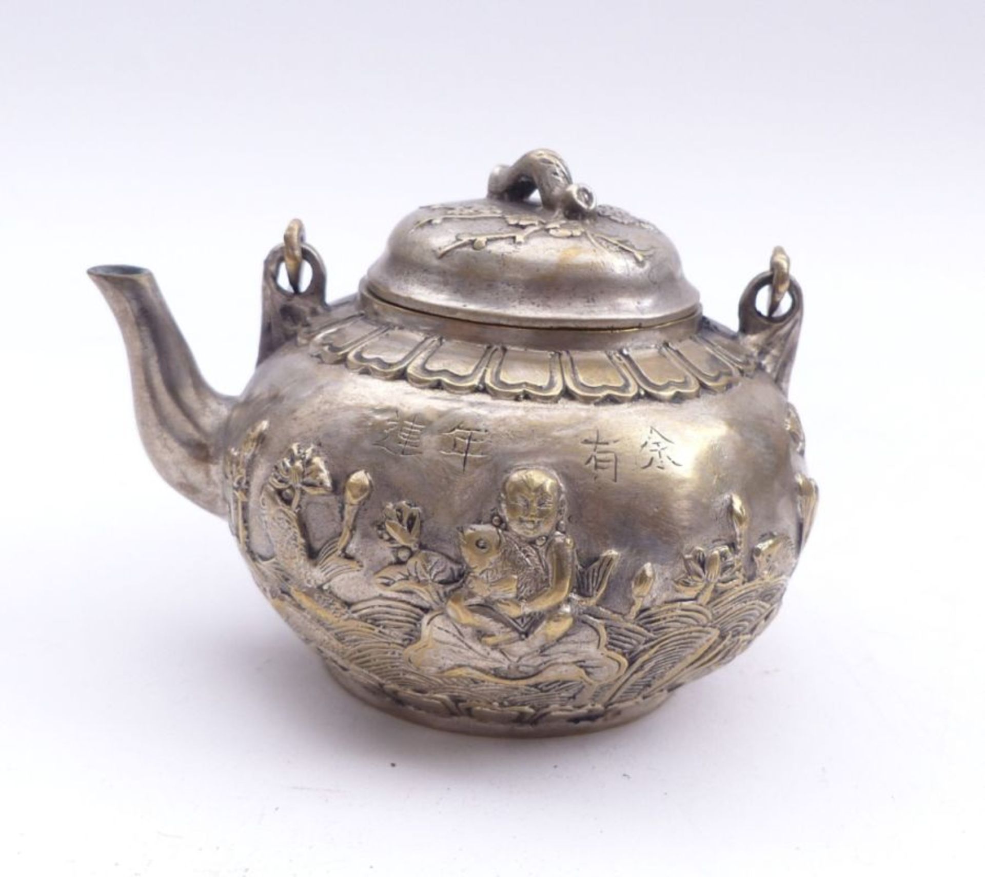 TeapotChinaWith curved spout and movable handle; relief decoration of sea waves with fish and a
