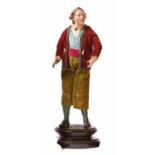 Neapolitan crib figure - BoyLate 18th centuryBoy standing on a profiled pedestal in a red jacket.