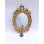 Small Louis-XVI-wall-mirrorGermany, around 1800Oval frame, crowned with openwork bow, candlestick