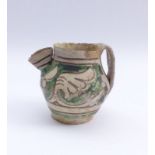 Jug with leaf decorationTuscany, 18th c.With short, pressed tubular spout and wide strap handle.