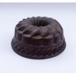 Baking mould19th centuryRound, multi-zone form with openwork inner tube, flanged rim. Copper with