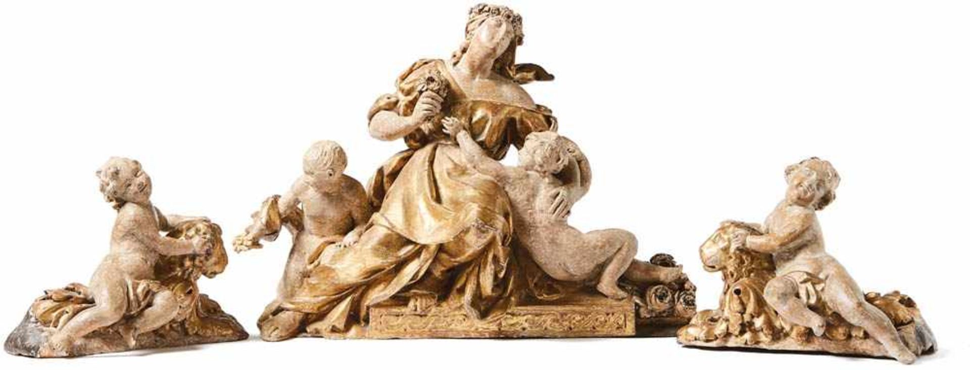 Flora with putti18th century3-pcs. goddess sitting on pedestal, surrounded by two putti, holding