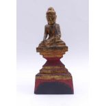 Sitting BuddhaBurma, about 1850Sitting on a high and stepped triangular pedestal in a simple monk'