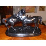 Horse group19th centuryTwo facing horses standing on an oval natural pedestal, similar to the