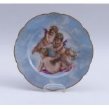 Decorative plate with putti19th century.Flat, round shape with curved rim; colourfully painted