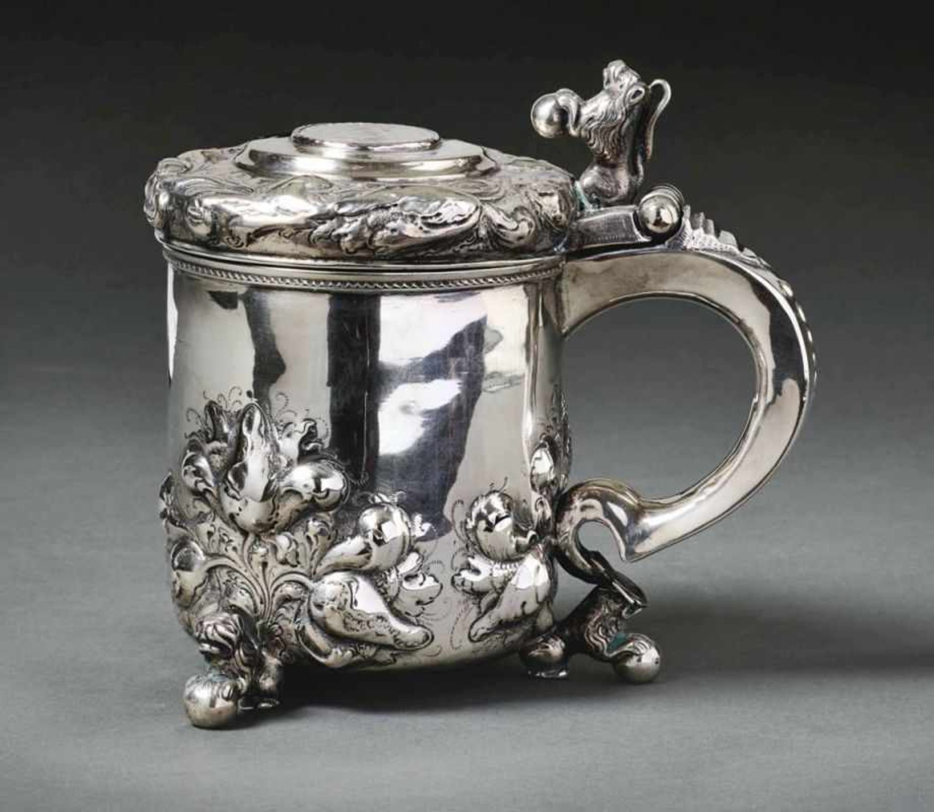 Tankard with lidSwedenCylindrical corpus on three ball feet held by lions, broad C-handle with