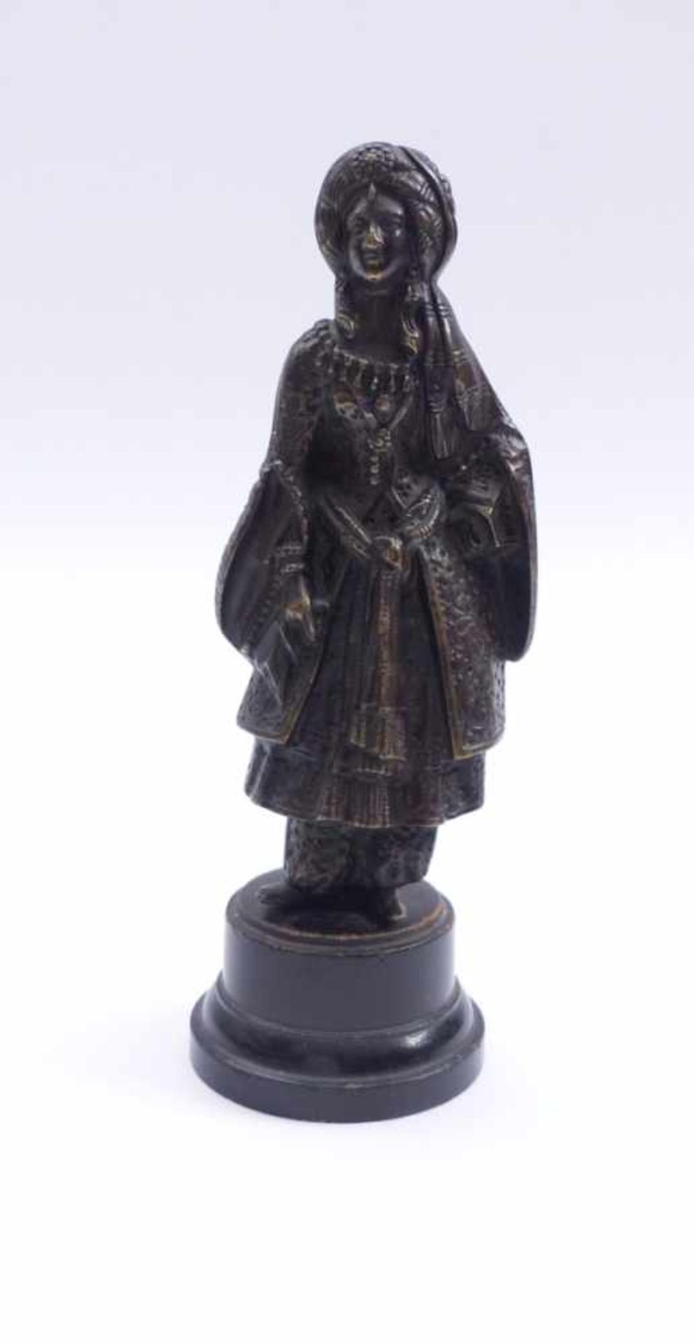 Oriental19th centuryA young woman in oriental costume standing on a round, profiled pedestal as a