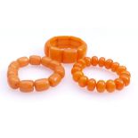 Three amber bracelets20th centuryAll-round rectangular cabochon elements, polished lenses and