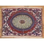 KeshanIran, 19th/20th c.Worked in relief, oval medallion surrounded by flower twigs. Wool. 97 x 72
