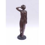 Female NudeGoldscheider, Vienna - around 1960Young woman standing on a round plinth, holding a cloth