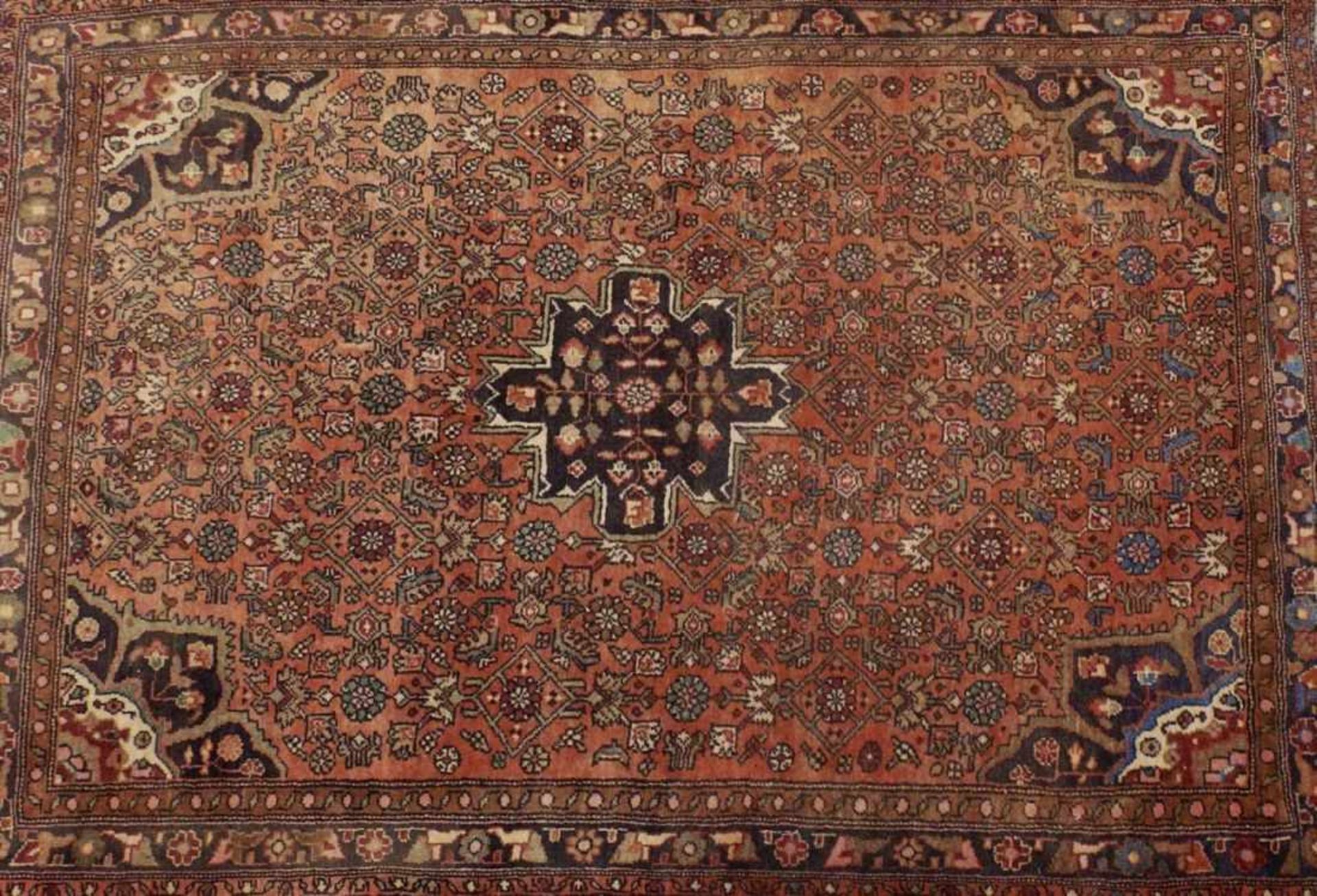 Bijar SandjanIran, 20th c.Red ground with ornaments and flower motifs in blue and beige. Wool. 150 x