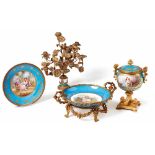 Four pieces of decorative porcelainSèvres, 2nd half of 19th century.Bonbonnière with lid, h. 29,5 cm