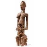 Big mother figureWest Africa, Ivory Coast - 1st half 20th c.Woman sitting on a small stool with a