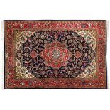 GhomIran, 20th c.In strong shades of blue and red, tendril border, centre field with large cartouche