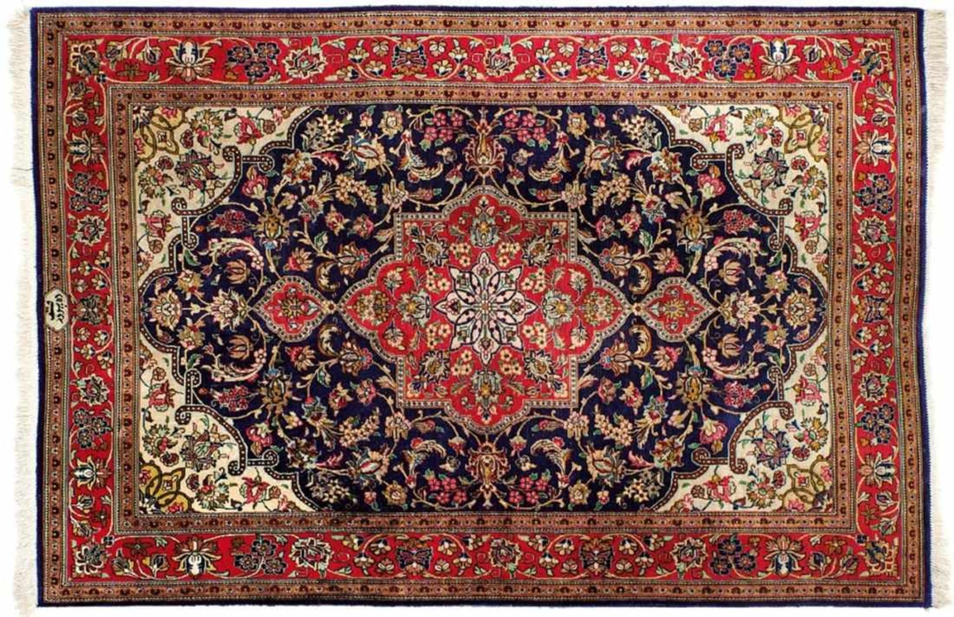 GhomIran, 20th c.In strong shades of blue and red, tendril border, centre field with large cartouche