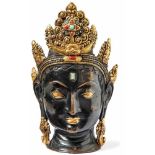 Bodhisattva HeadTibetThe head is decorated with a richly decorated leaf crown (Tathagata), the