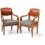 Pair of Empire armchairsRussia, Beg. 19th c.On curved volute legs with stylized leaf carving,