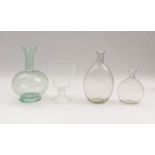 Four vessels18th C. and laterTwo bottles of blown colorless glass (G. 15 and 23 cm). A bottle of