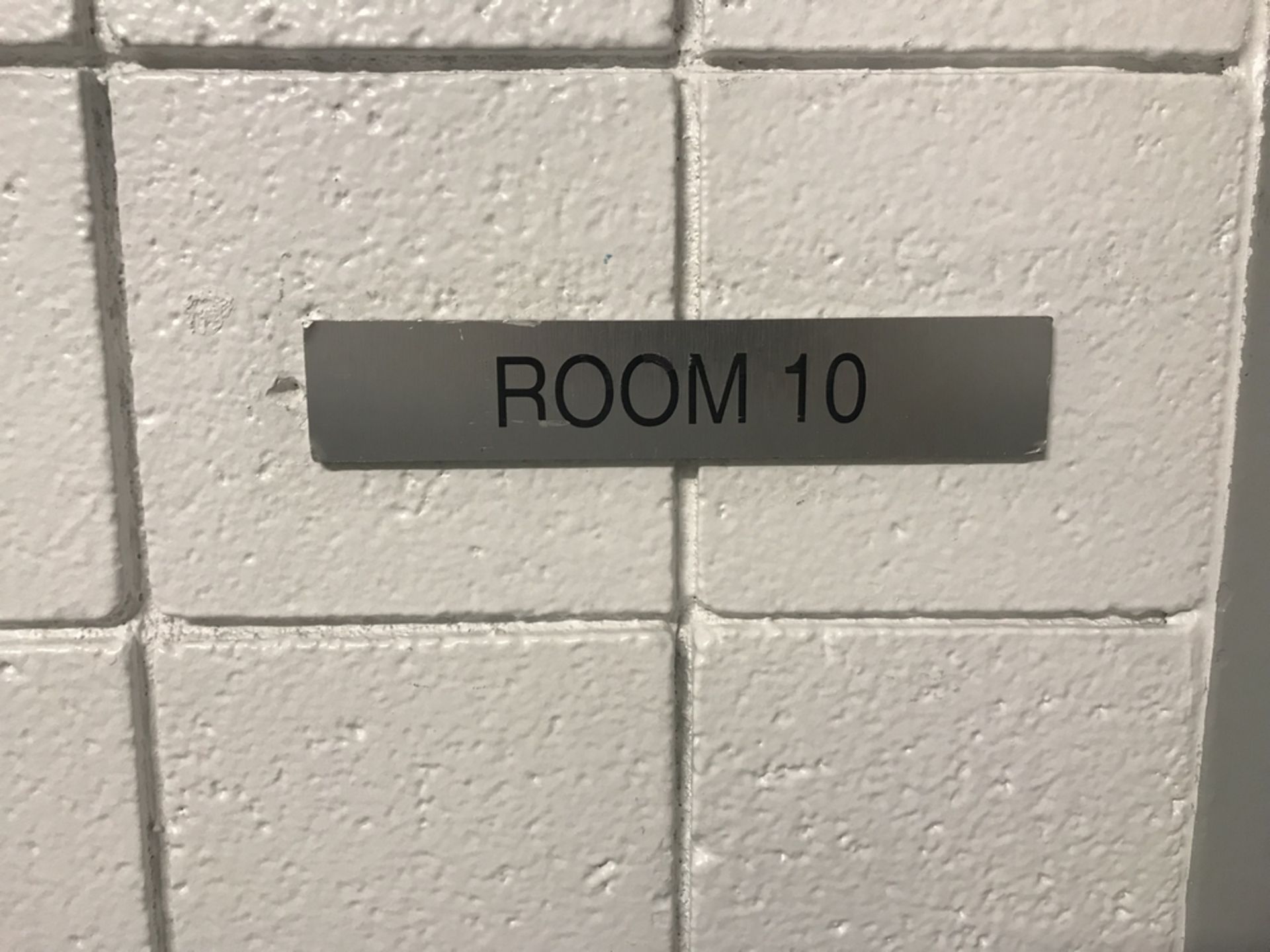 "Room 10" Sign Visitors Locker Rm. , Dim. 10 in x 2 in , Location: Visitors Locker Rm. ***Note