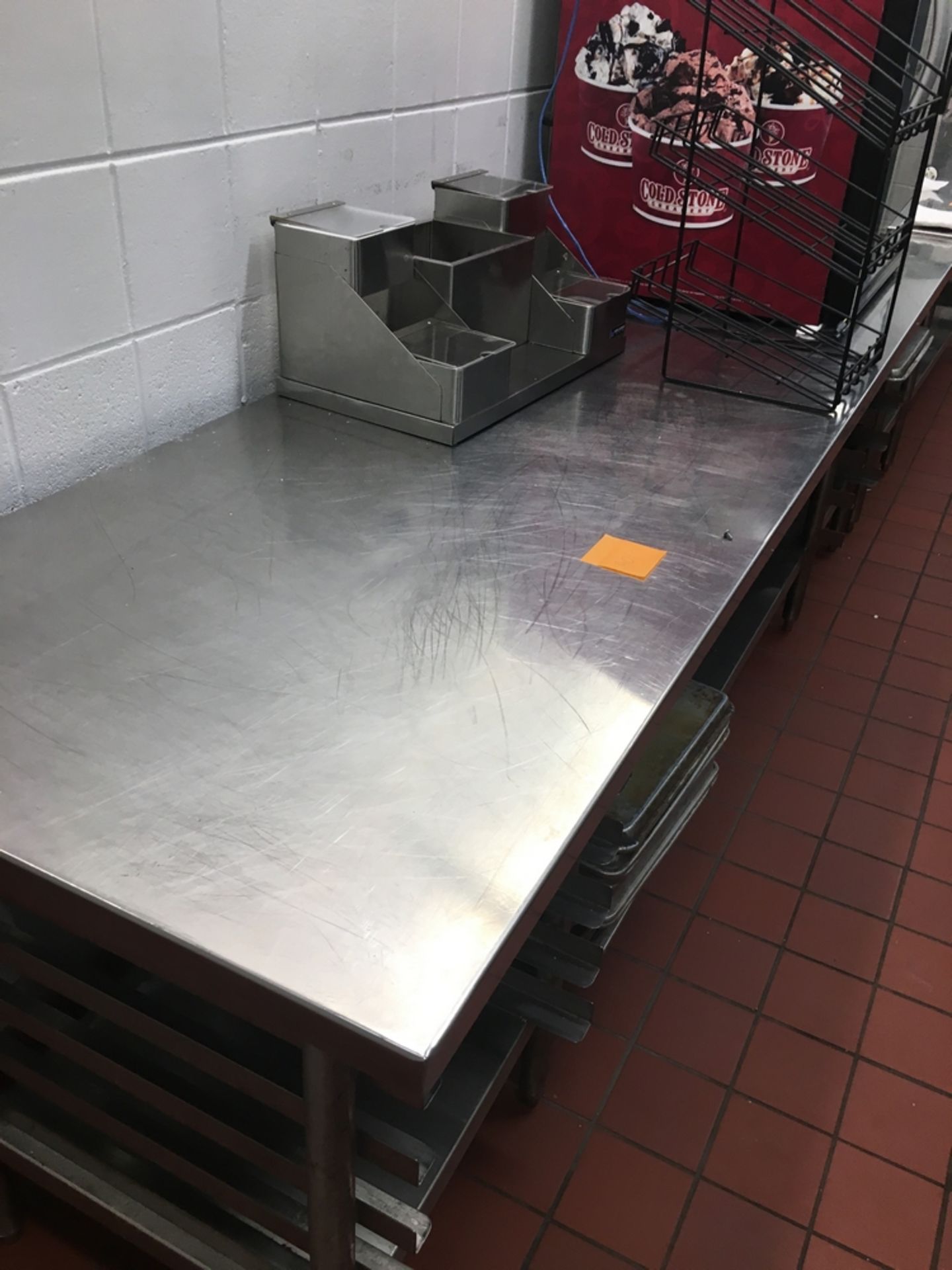 SS Table, w/ tray holder, 9 x 2 1/2 x 3 ft. OVERSIZED Located: Pistons Coneys 128 - 229 Asset #: N/A