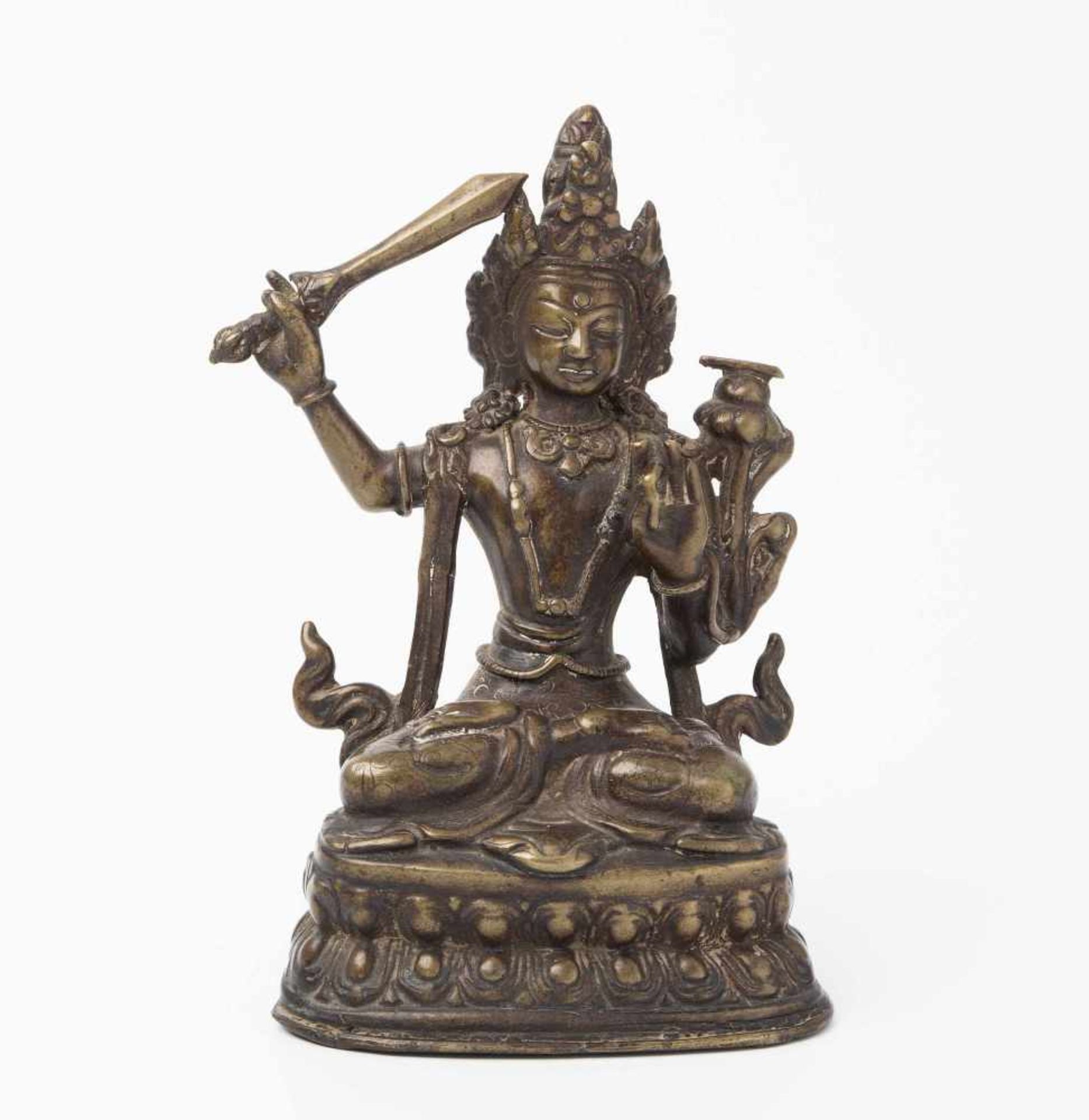 ManjushriNepal. Bronze. Auf doppeltem Lotossockel in padmasana sitzender Manjushri, seine rechte