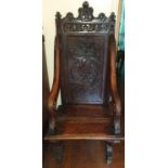 A 19th Century, possibly earlier, Oak Hall Chair with an X frame stretcher base, pierced arms and