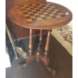 A 19th Century Walnut Games Table with a Chessboard top. 67 cms high.