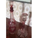 A 19th Century Cranberry glass Decanter along with a 19th Century Cranberry glass Candlestick.