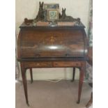 A late 19th Rosewood Cylinder Writing Desk with a highly inlaid front on square tapered supports and