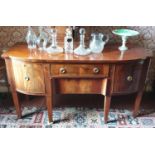 A Regency Mahogany Sideboard with a bow front outline and centre drawer. Drawer flanked with two