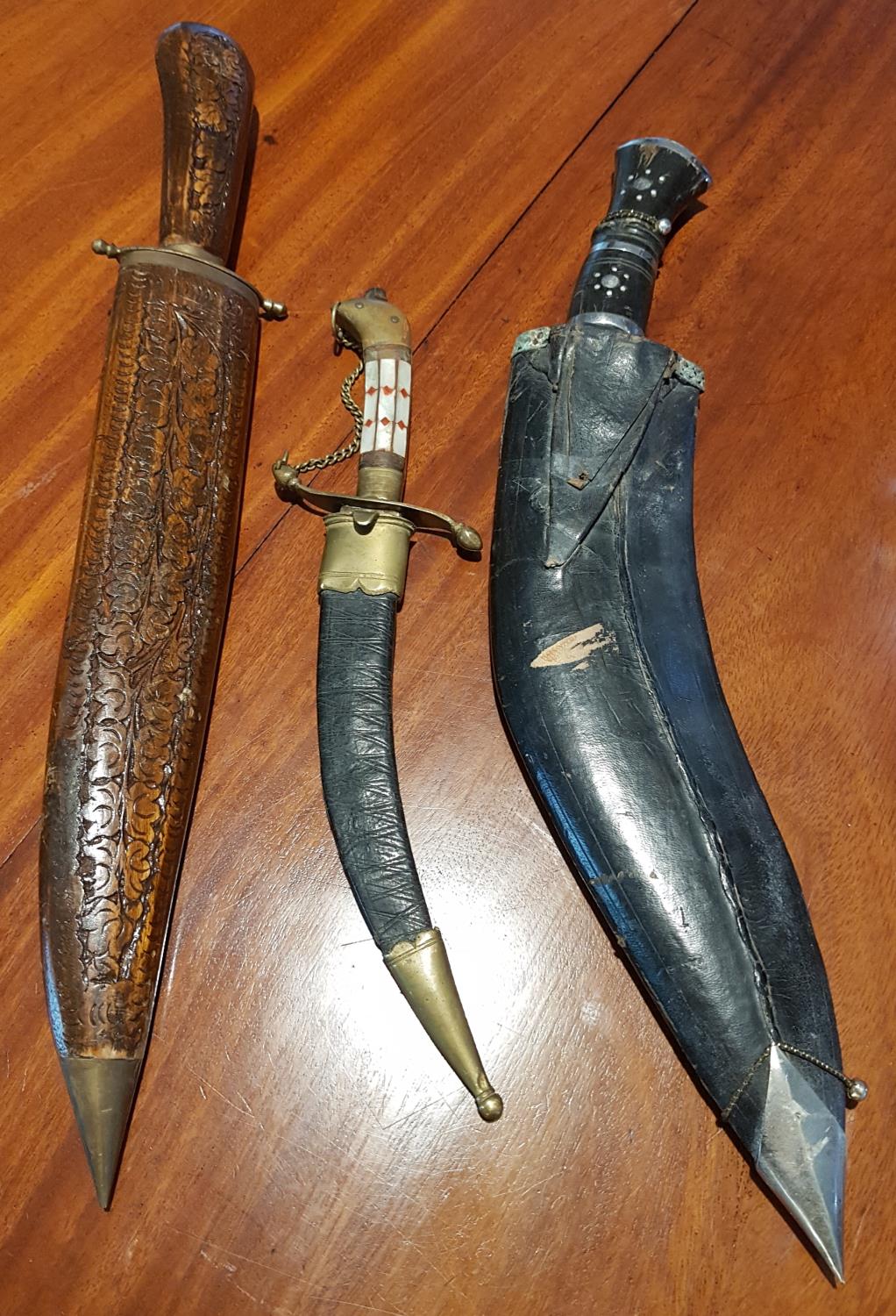 A Kukri along with two other knives.