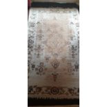 A well worn Cream Ground Rug. 216 x 126cm.