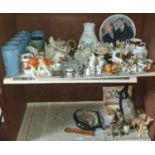 A group of Belleek along with various other Items in bottom left cupboard of narrow bookcases.