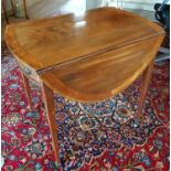 An early 19th Century Mahogany Pembroke Table with Satinwood Crossbanding on square tapered supports