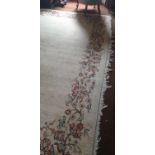 A very large Cream Ground Rug with centre motif. 550 x 375cm.