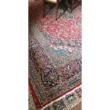 A fine woven Iranian carpet with red ground of Kashan origin traditional design. L404cm X W303cm.