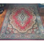 A large Burgundy ground Rug with allover decoration and multi borders. 280cm X 201cm