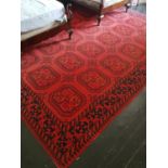 A good Burgundy ground Rug with repeating decoration. 354cm X 274cm