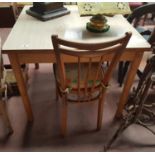 A Kitchen Table and two Chairs.