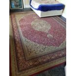 A large Burgundy ground Rug with allover decoration and multi borders. 363cm X 276cm