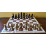 A Brass and Metal Chess Set on board.