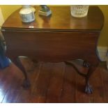 A Modern Mahogany Serpentine shaped Dropleaf Table with carved ball and claw feet. W 81 L 103 H