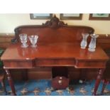 A 19th Century Mahogany Serving Table with a concave drawer front and galley back on turned