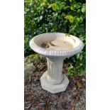 A Stone Bird Bath with columned supports.